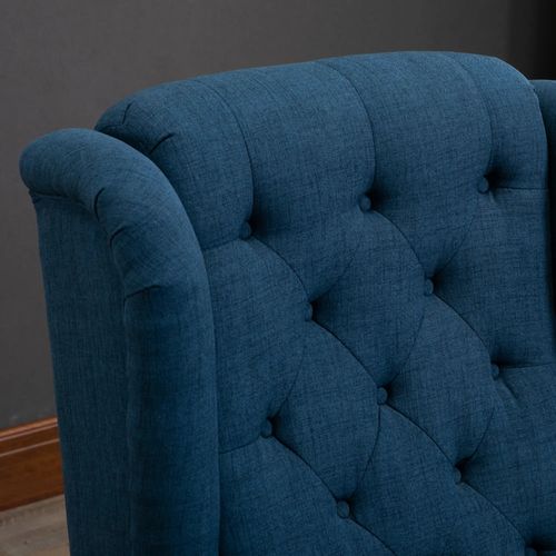 Fauteuil à oreilles capitonné bleu, dossier haut, accoudoirs arrondis, pieds en bois, bleu